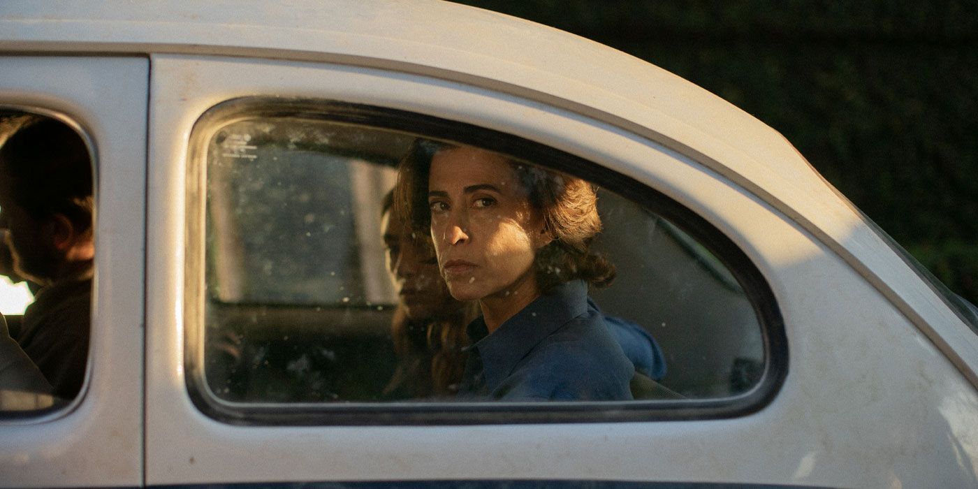 Fernanda Torres looking out a window from inside a car in I'm Still Here