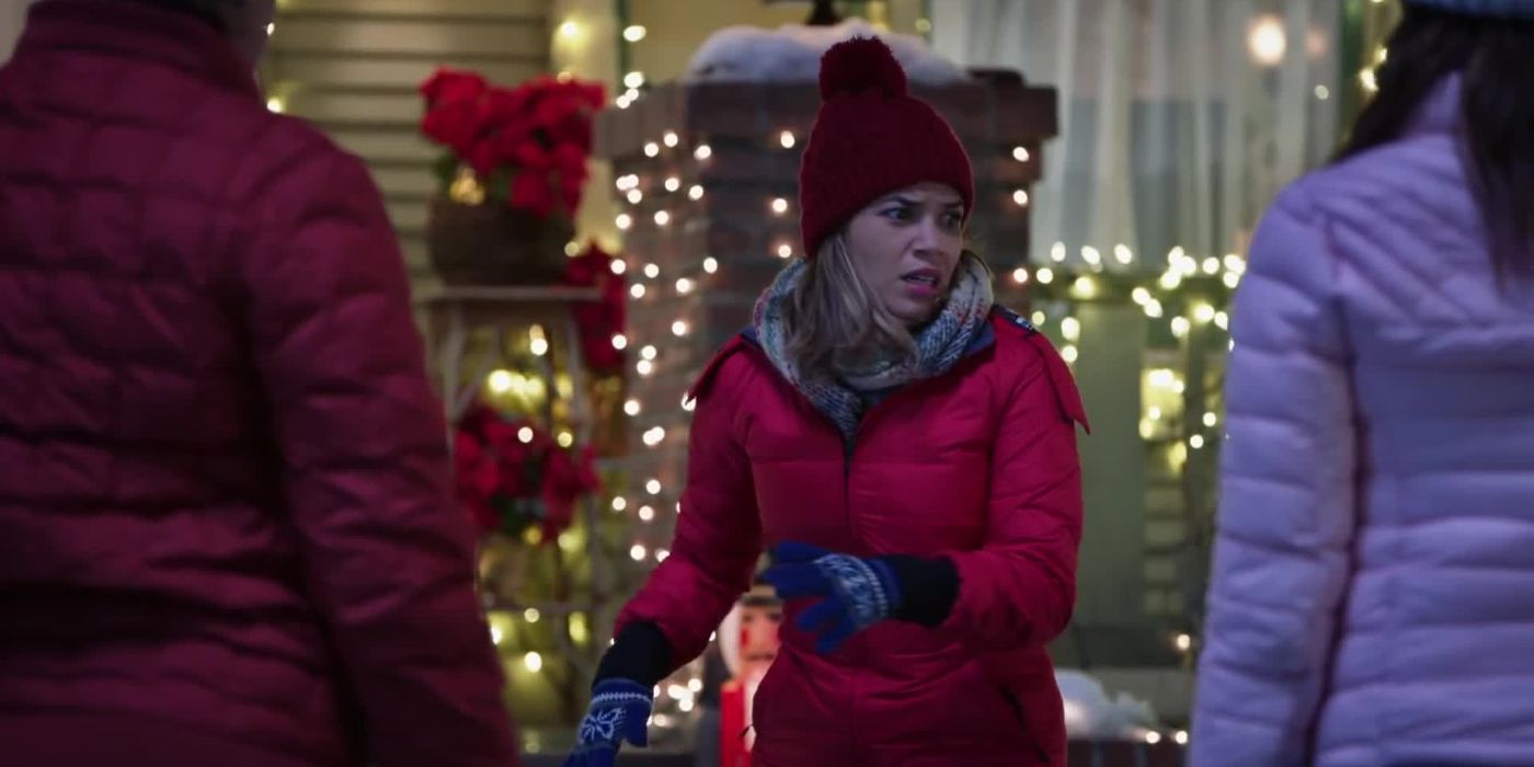 Amy, played by America Ferrera, standing outside in a red puffer jacket in Superstore.