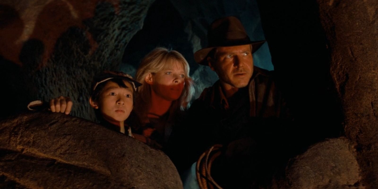 Short Round, Willie Scott and Indiana Jones peak out of a cave in 'Indiana Jones and the Temple of Doom'.