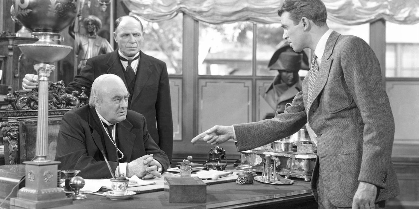 Jimmy Stewart as George Bailey points a finger at  Lionel Barrymore as Mr. Potter in It's a Wonderful Life