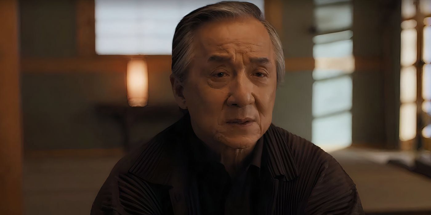 Jackie Chan as Mr. Han in Karate Kid: Legends talking seriously to someone