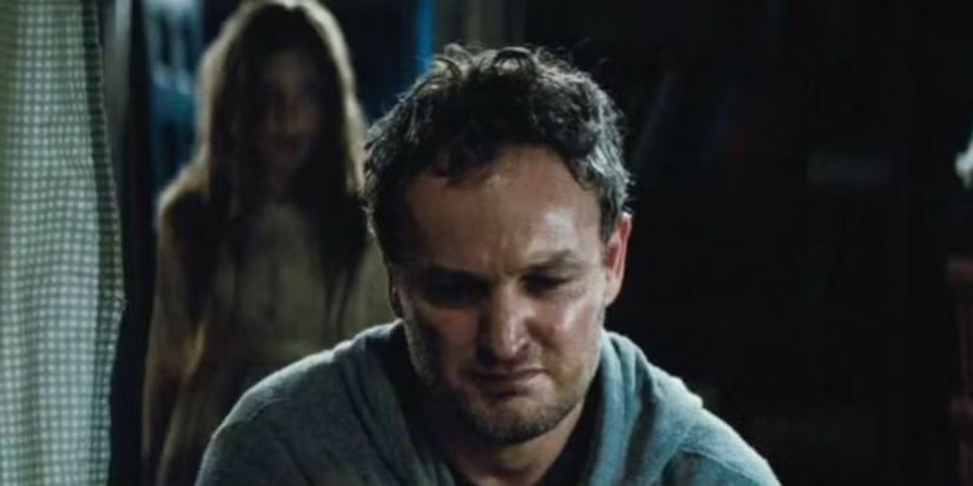 Jason Clarke looks down distraught in Pet Sematary.