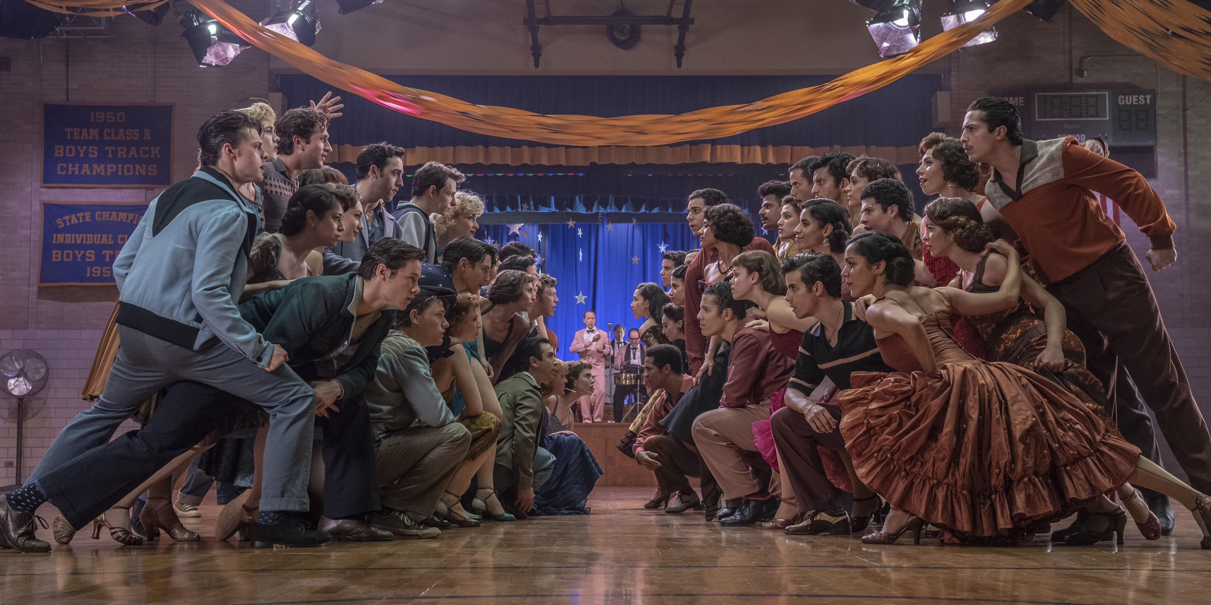 The rival gangs of West Side Story, the Jets and the Sharks, staring each other down at the dance.
