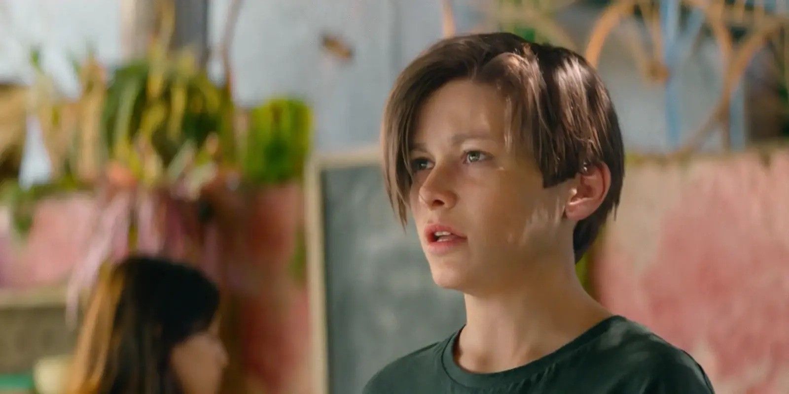 A young John Connor in Terminator: Dark Fate, relaxing at a beach