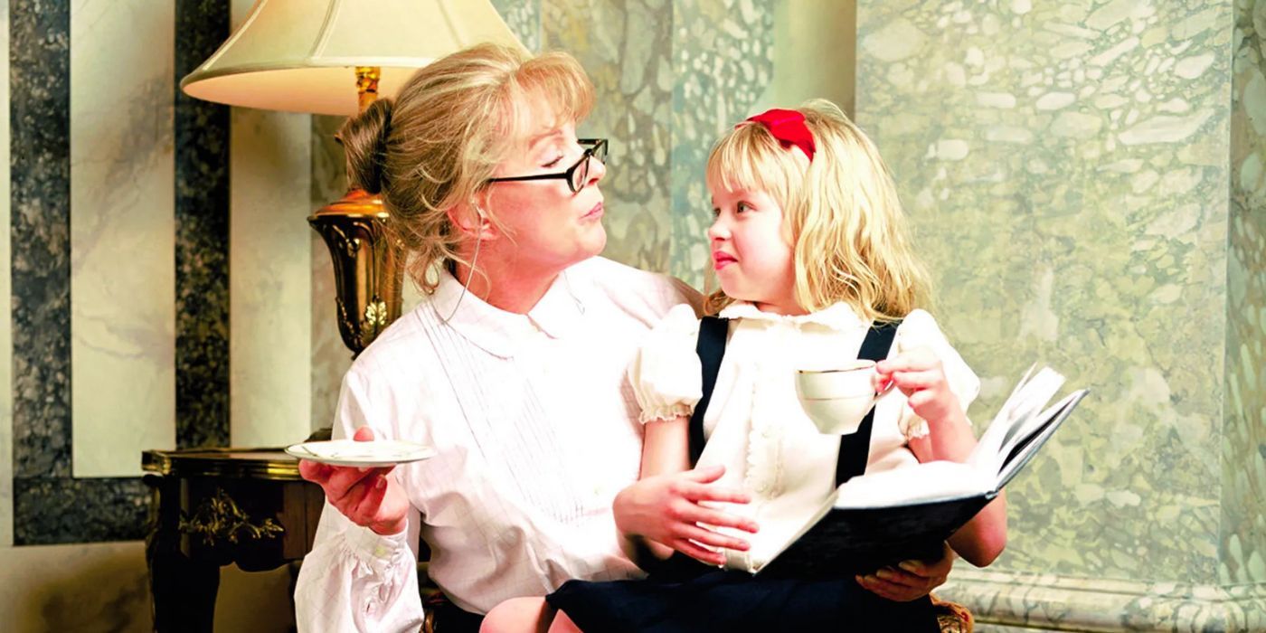 Sofia Vassilieva sits on Julie Andrews' lap as they read a book and have tea in Eloise at the Plaza.