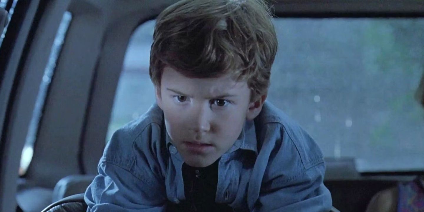 Tim inside a car looking intently ahead in Jurassic Park