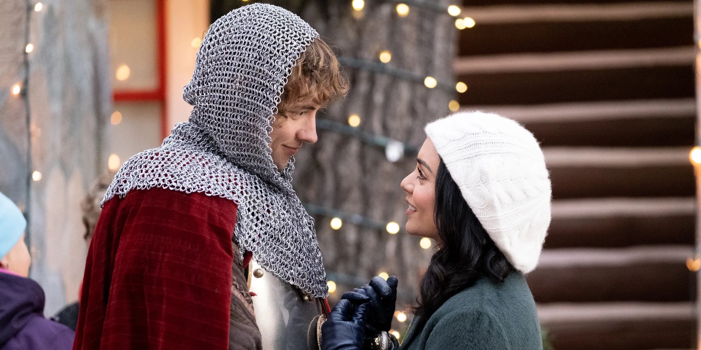 John Whitehouse as Sir Cole, the 14th century knight, and Vanessa Hudgens as Brooke Winters looking into each other’s eyes in Netflix’s 2019 Christmas rom-com The Knight Before Christmas