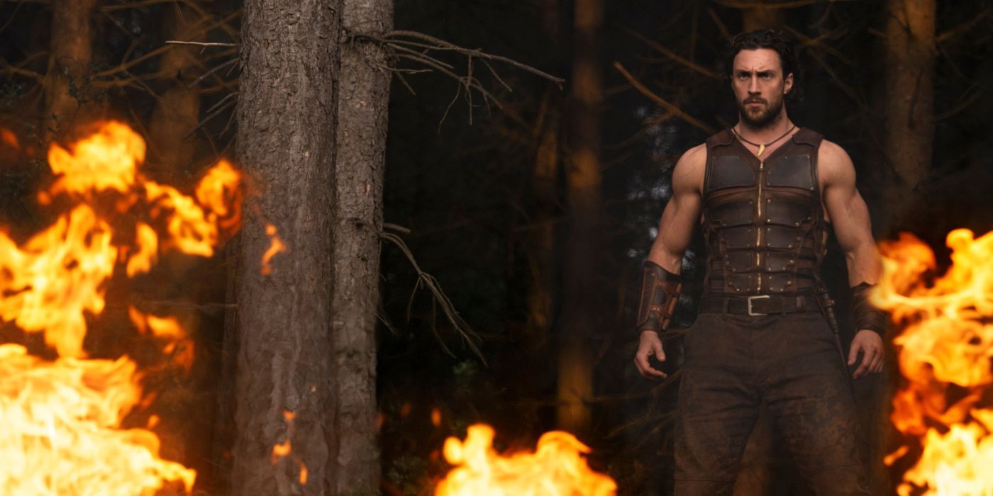 Aaron Taylor-Johnson standing amidst flames as Kraven the Hunter.