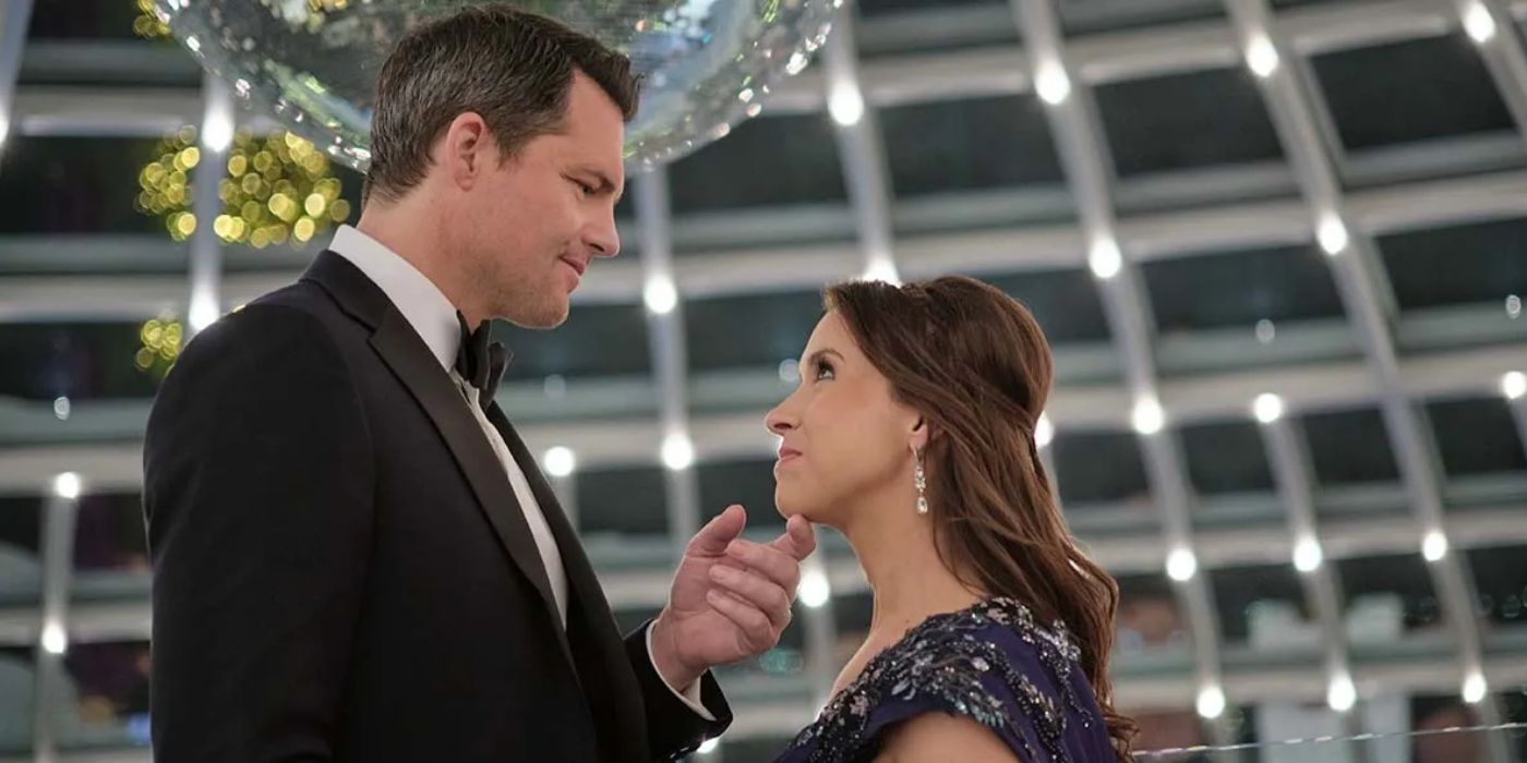 Kristoffer Polaha holding Lacey Chabert&rsquo;s chin as they stare at each other in &lsquo;The Christmas Quest&rsquo;.