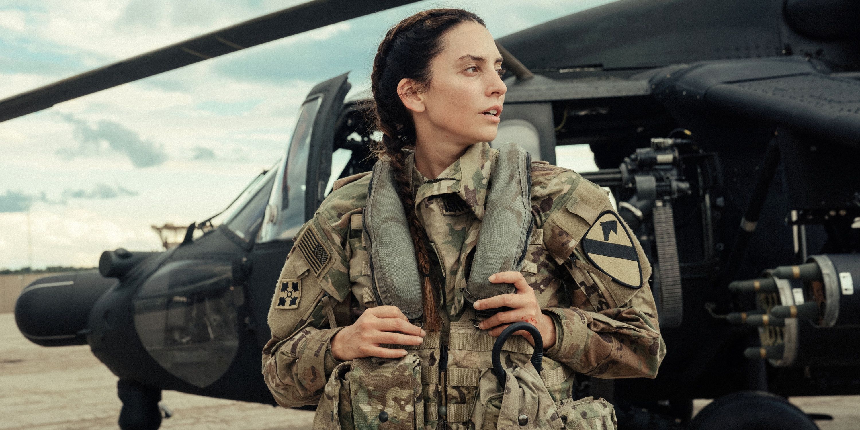 Genesis Rodriguez as Josie standing in front of her helicopter in Season 2 of Lioness
