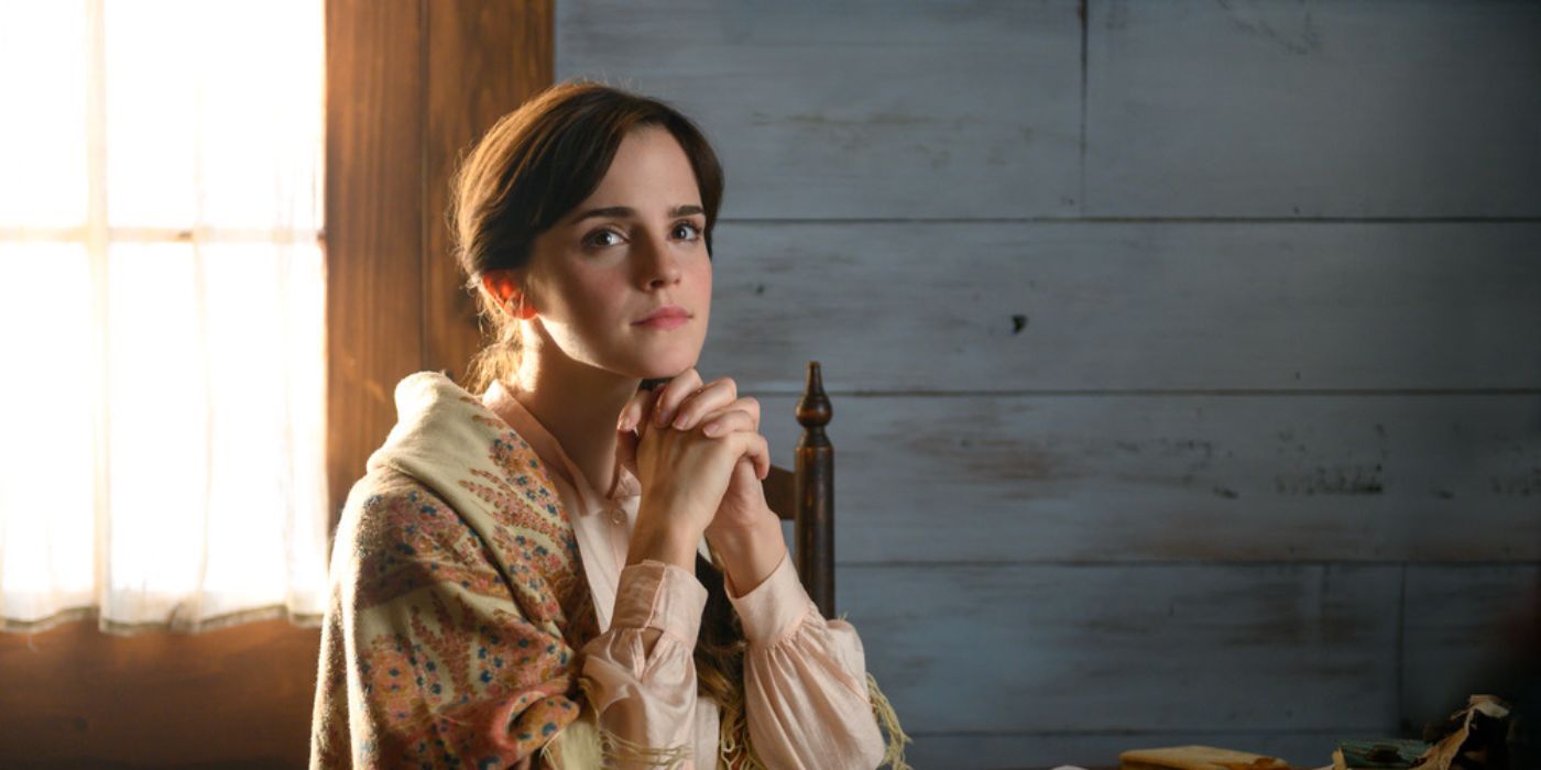 Meg March, played by Emma Watson, sits with her hands folded together in 'Little Women.'