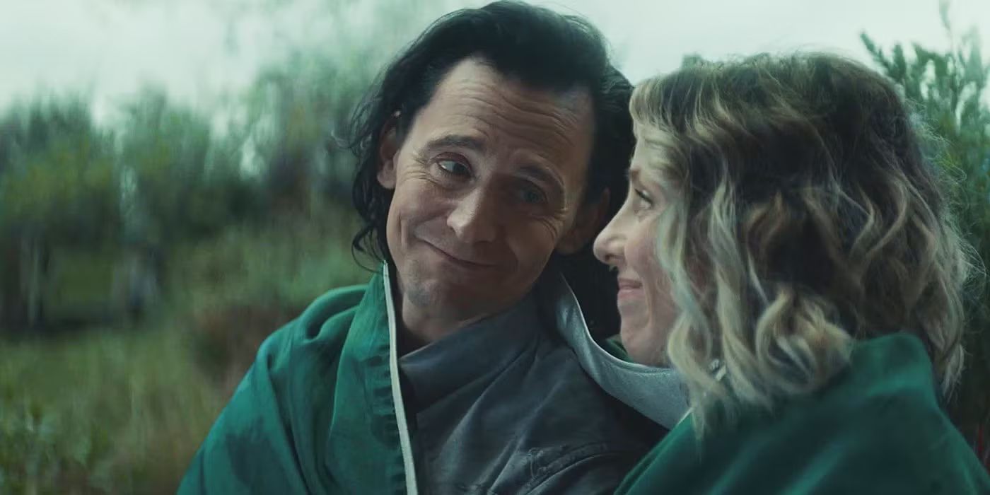 Loki looking at Sylvie smiling in a blanket in Loki