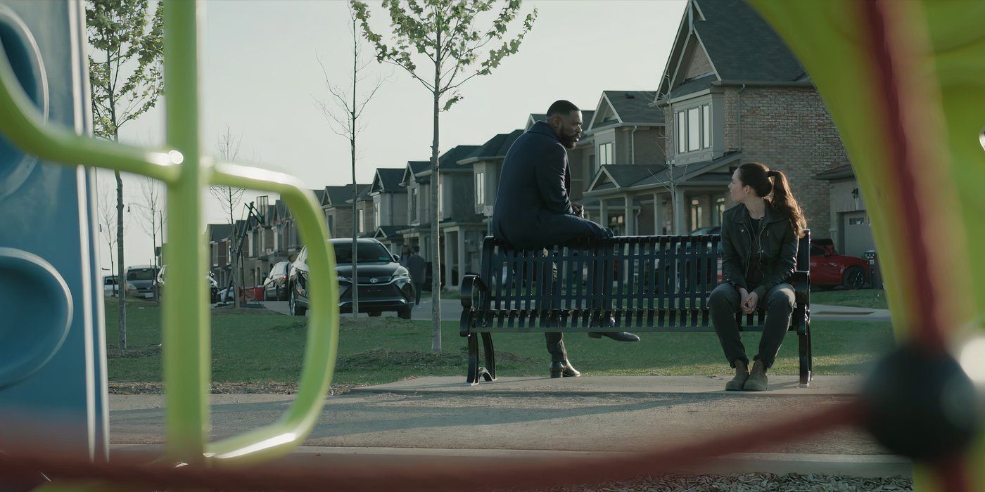 Tamsin Topolski as Lucie Simon and Colman Domingo as Muncie sit on a bench at a children's playground in The Madness.