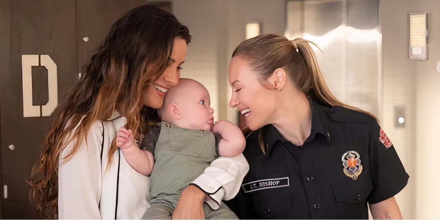 Maya and Carina smiling and holding their new baby on 'Station 19'.