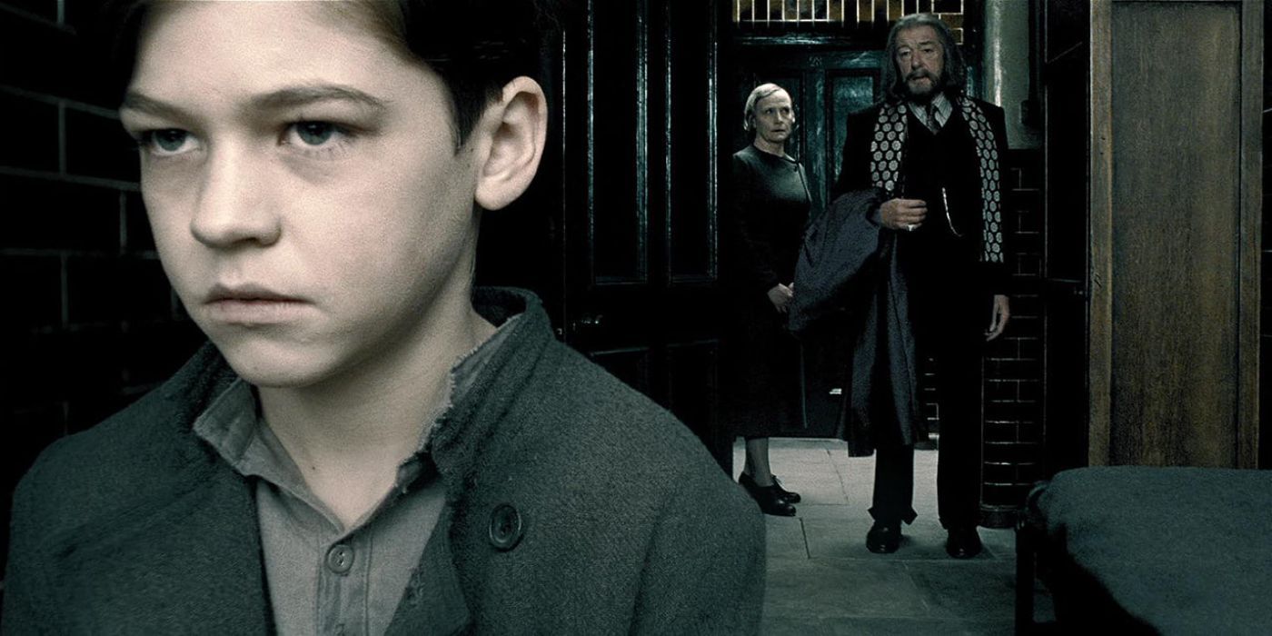 Dumbledore stands in a doorway as the boy Tom Riddle looks away in Harry Potter and the Half-Blood Prince.