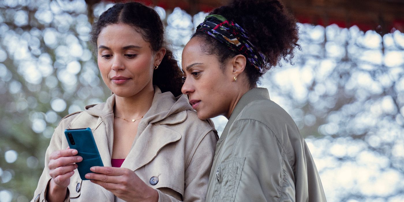 Rosalind Eleazar and Jessica Plummer looking at a cell phone