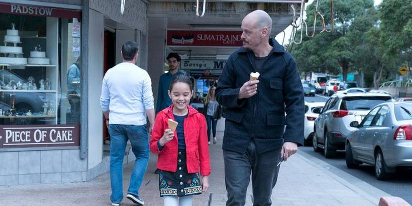 Roy and Brittany eating ice cream and walking down a street in Mr. Inbetween.
