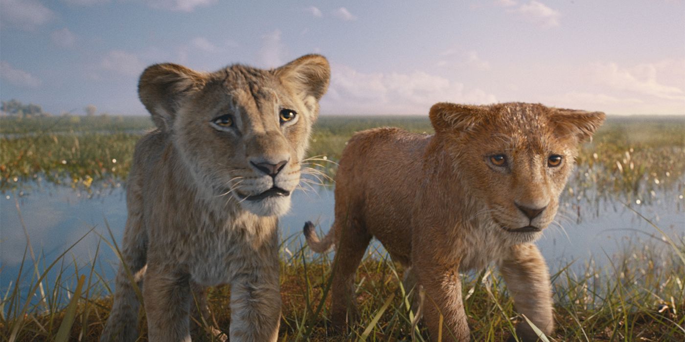 Young Mufasa (Braelyn Rankins) and Young Taka (Theo Somolu) standing on the bank of a river