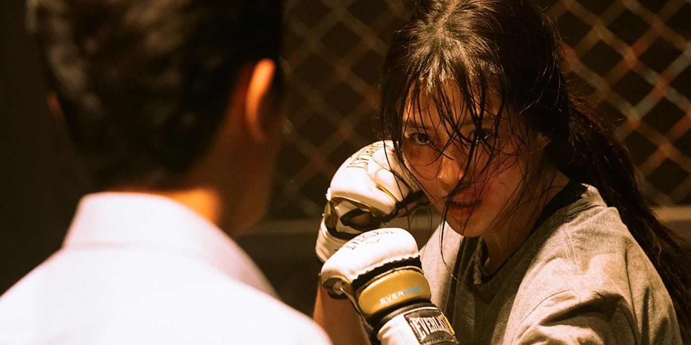 Ji-woo (Han So-hee) boxing with her fists raised and her sweaty hair falling in her face in My Name.