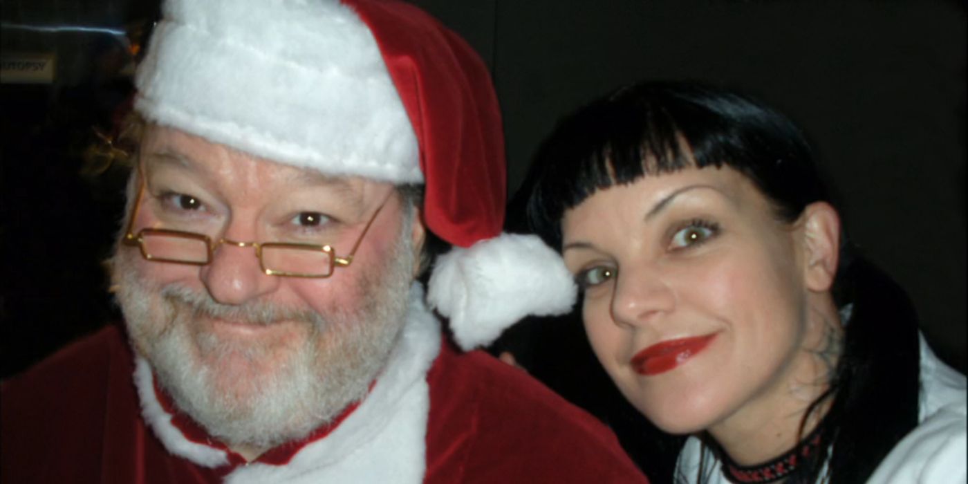 Abby Sciuto (Pauley Perrette) taking a picture with Dr. Pryor (Charles Carroll) dressed as Santa Claus in NCIS