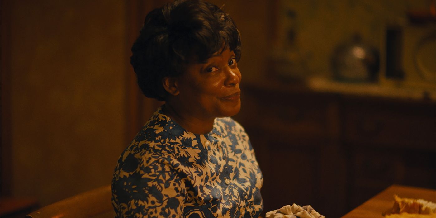 Hattie (Aunjanue Ellis-Taylor) smiling toward the camera with her head tilted in Nickel Boys