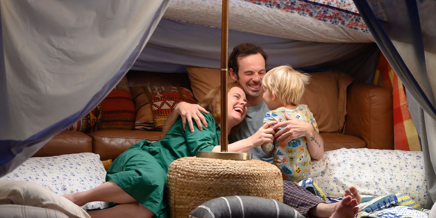 Mother (Amy Adams) and Husband (Scoot McNairy) laughing with their kid in a pillow fort in Nightbitch