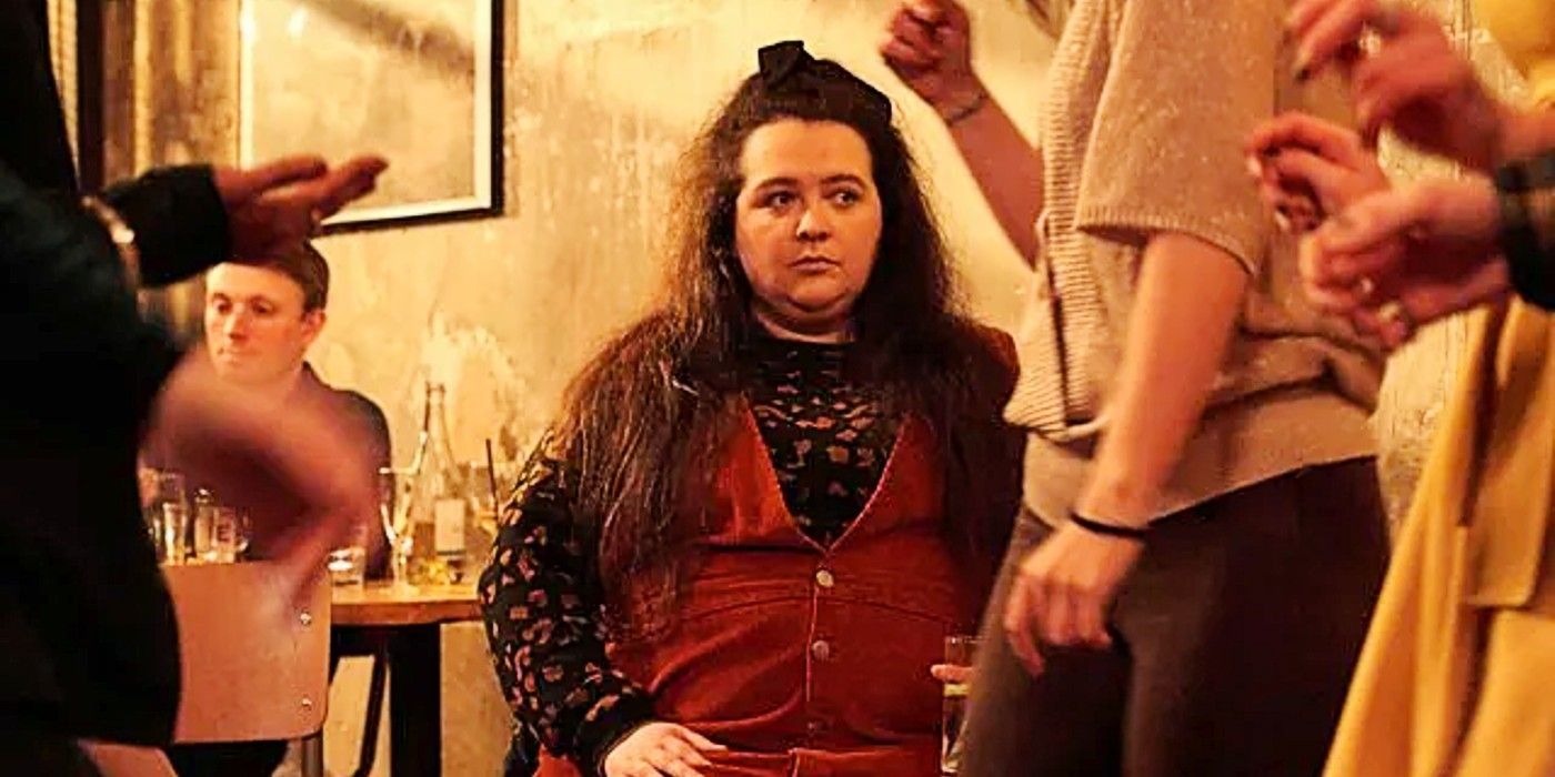 Nina standing alone at a party in Dinosaur