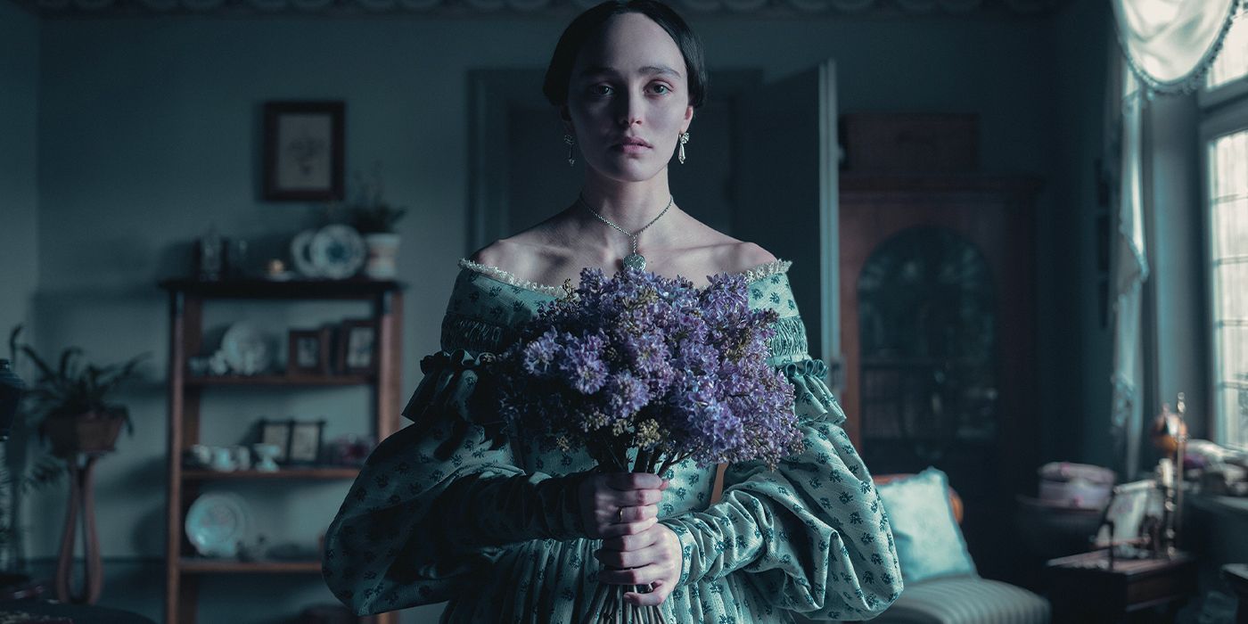 Lily-Rose Depp as Ellen Hutter holding a bouquet of flowers in Nosferatu