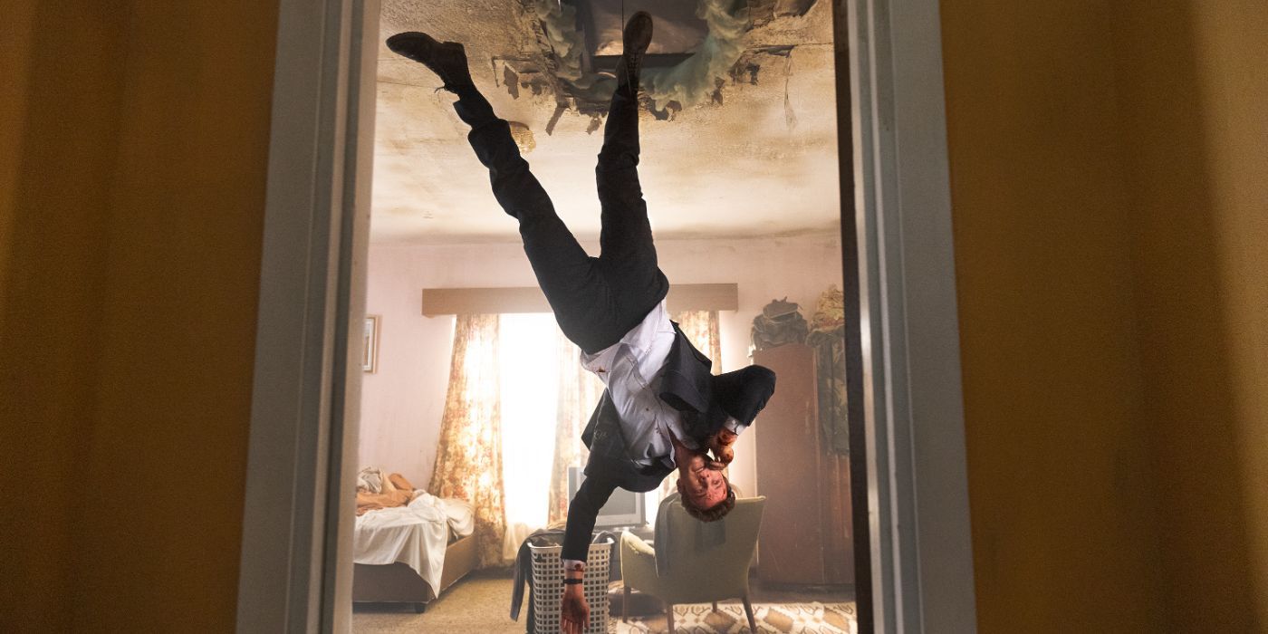 Jack Quaid as Nathan "Nate" Caine upside down falling through a hole on a ceiling in Novacaine 