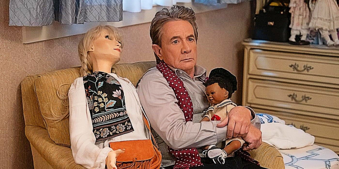 Oliver Putnam with a Meryl Streep doll and a baby doll in Only Murders in the building Season 4