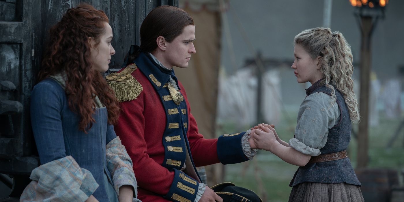 Charles Vandervaart talking to Silvia Presente while holding Florrie May Wilkinson's hand