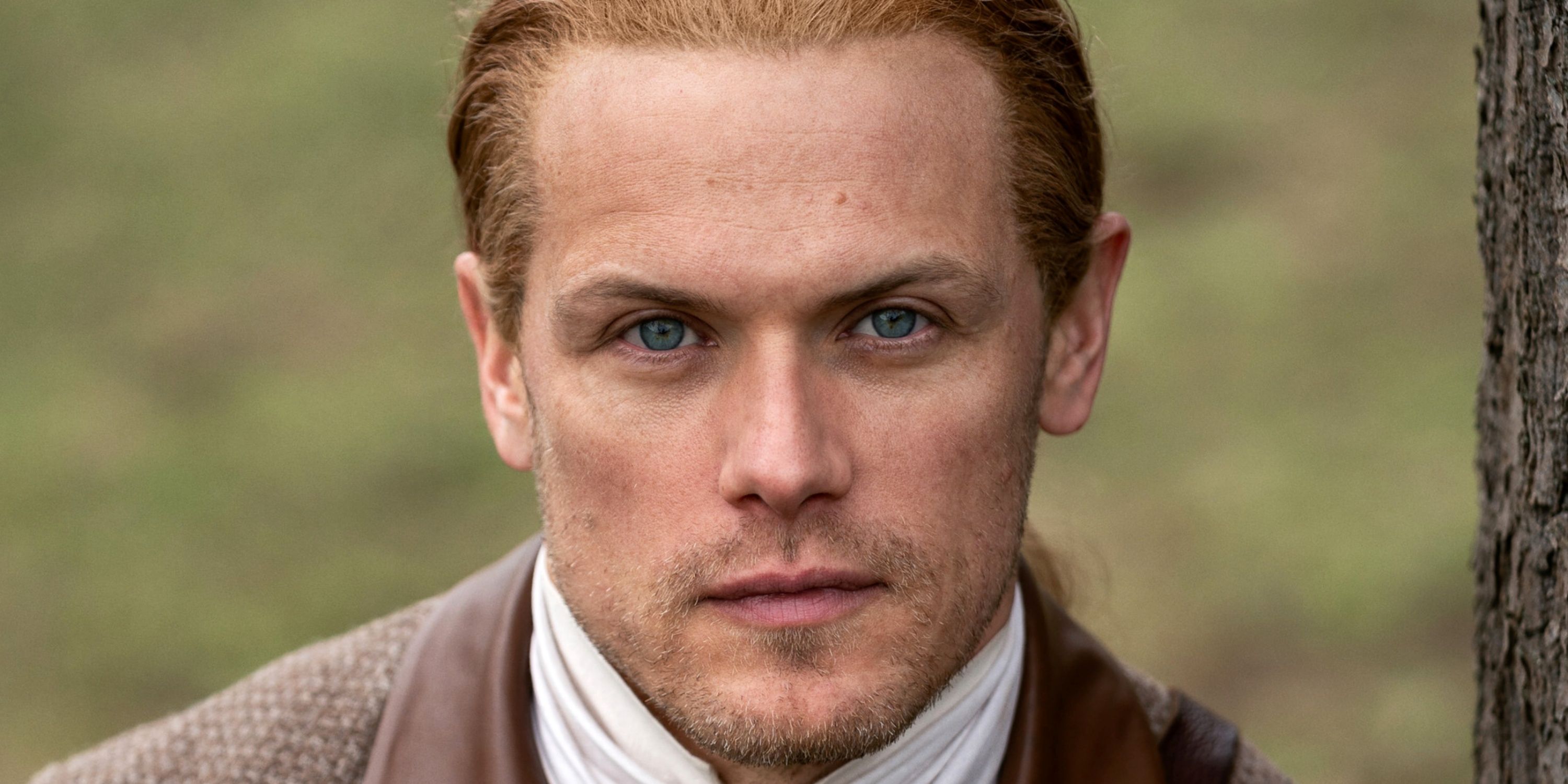 Sam Heughan as Jamie Fraser looking serious in close-up straight to the camera for Season 7 Pt 2 of Outlander