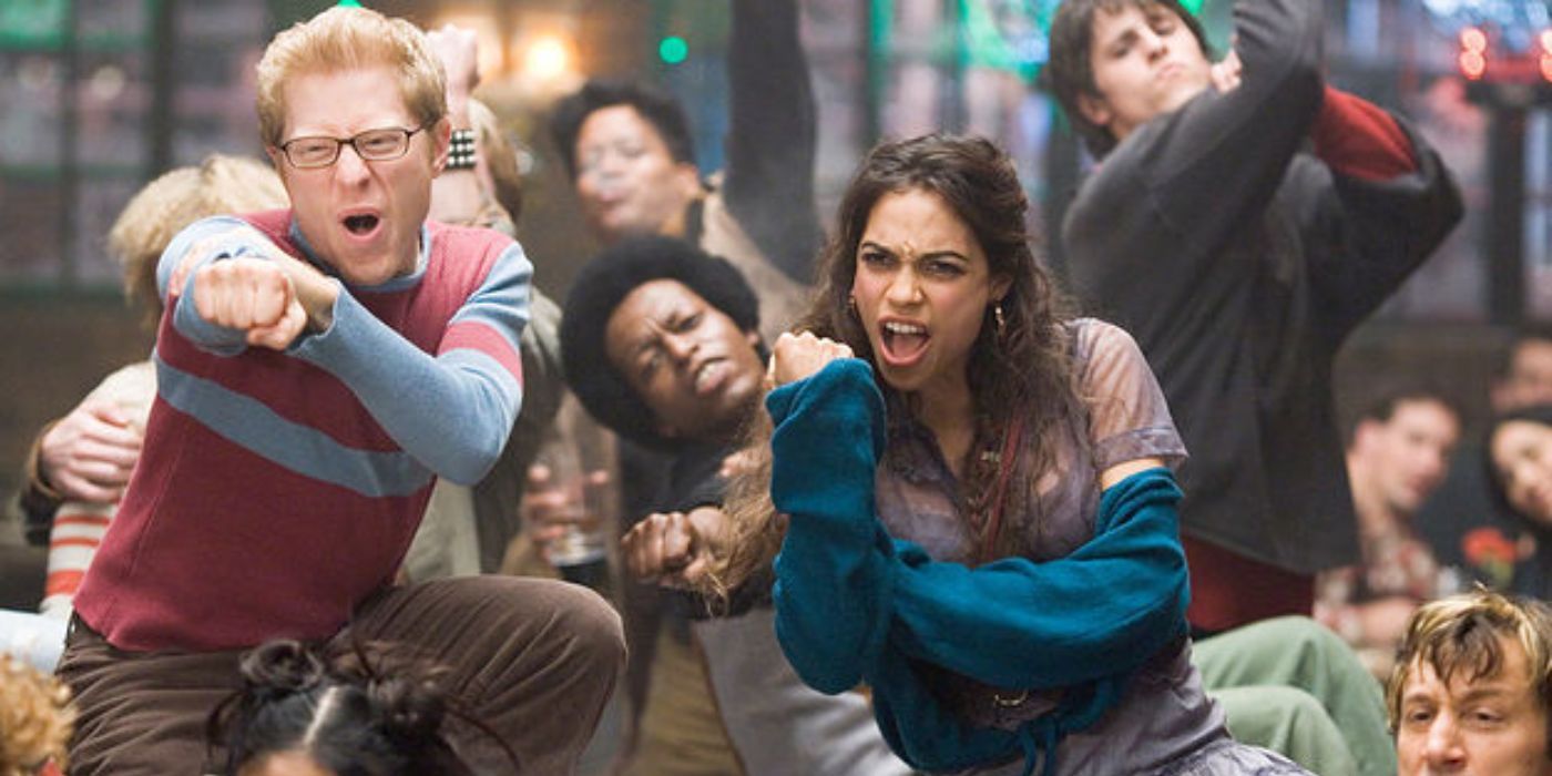 The cast of rent dancing in a cafe in Rent