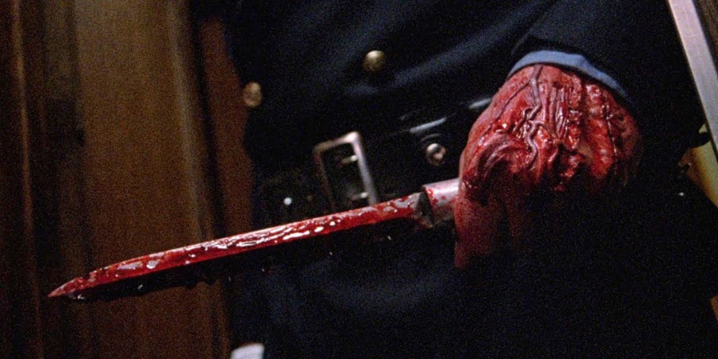 A bloody police officer holds a bloody blade in his hand in Maniac Cop 2 1990