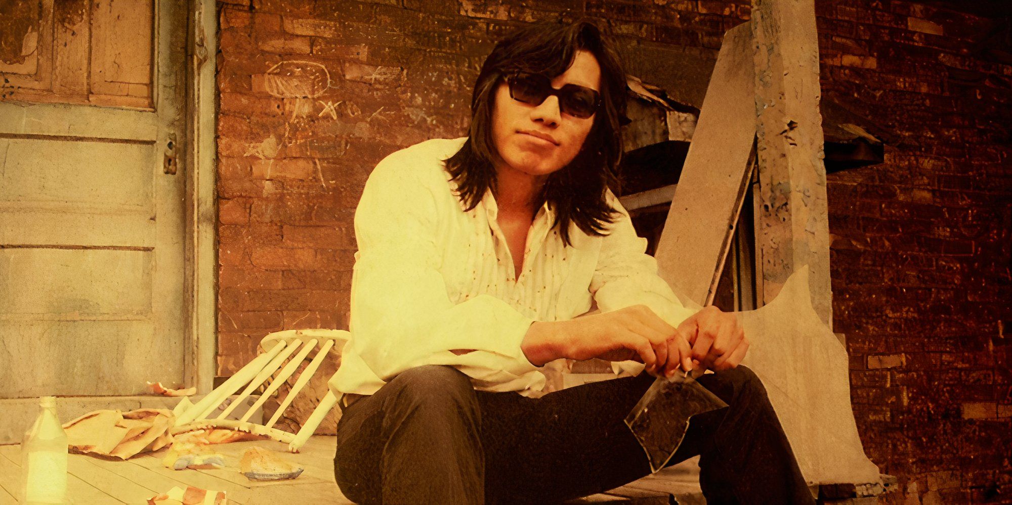 Rodriguez in Searching for Sugar Man sitting down 