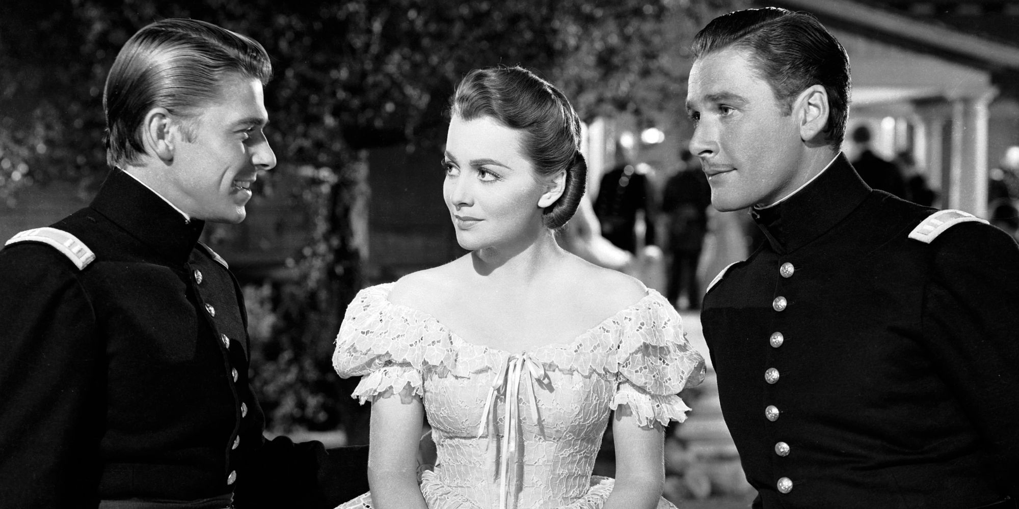 Ronald Reagan standing next to Olivia de Havilland and Errol Flynn in Santa Fe Trail (1940)