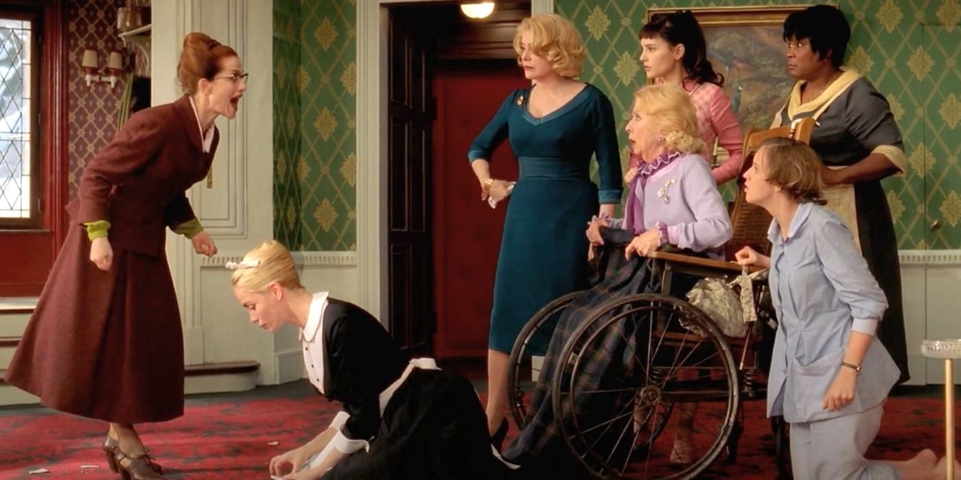 Augustine (Isabelle Huppert) screams at the cast ensemble of the Christmas mystery musical 8 Women.