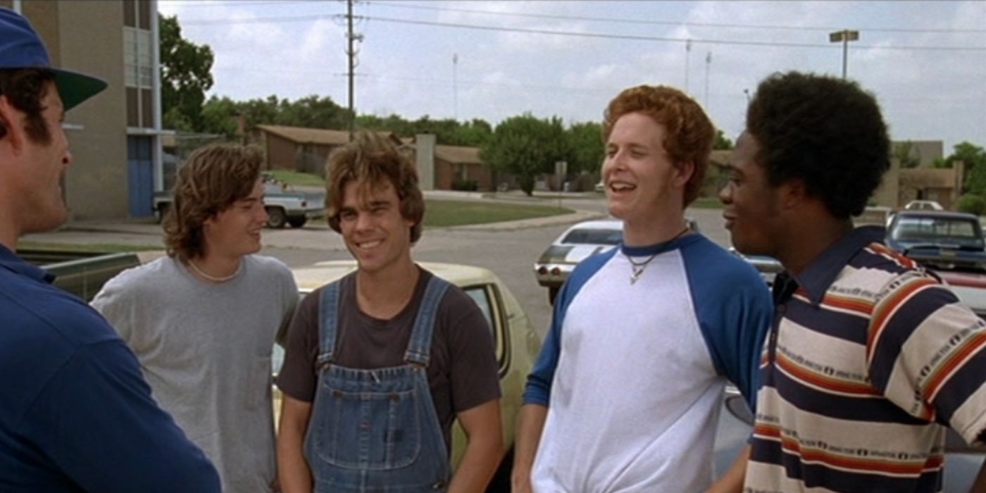 Cole Hauser as Benny wearing a blue and white shirt standing outside of a car in 'Dazed and Confused'