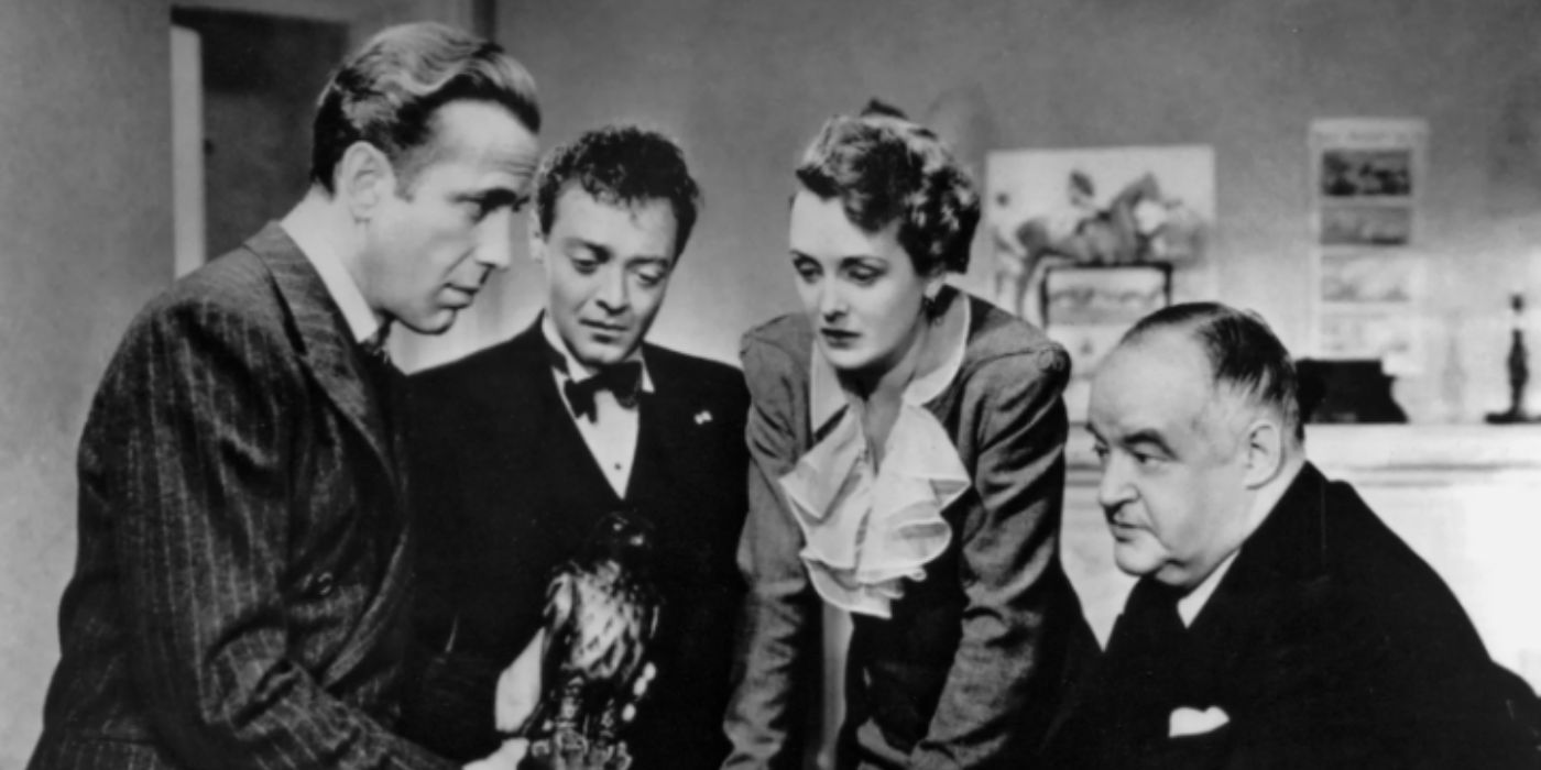 Humphrey Bogart, Peter Lorre, Mary Astor, Sydney Greenstreet as Sam, Joel, Ruth Wonderly, and Kasper looking at the Maltese Falcon in 'The Maltese Falcon'