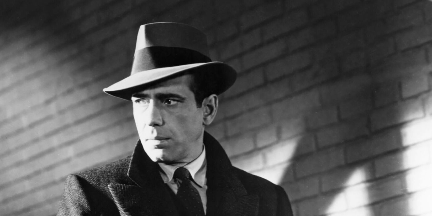 Humphrey Bogart as Sam Spade wearing a hat, trenchcoat, and tie in 'The Maltese Falcon'