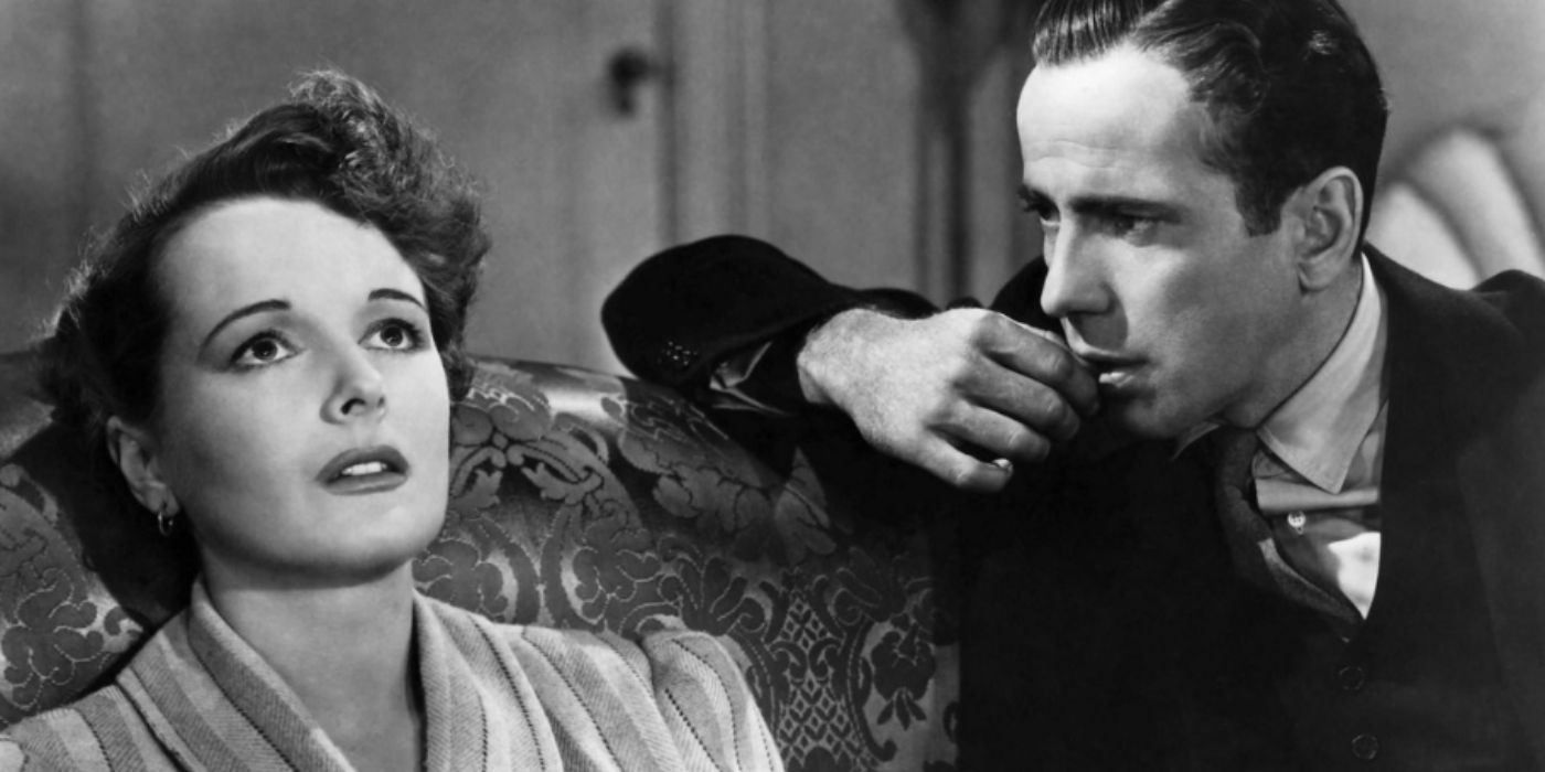 Mary and Humphrey Bogart as Ruth and Sam Spade sitting on a couch in a white shirt and a black suit in &lsquo;The Maltese Falcon&rsquo;