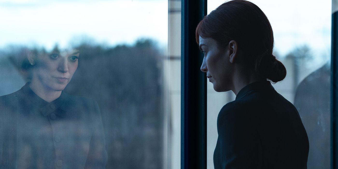 Helly (Britt Lower) looking out a window with her reflection in the glass in Severance Season 2