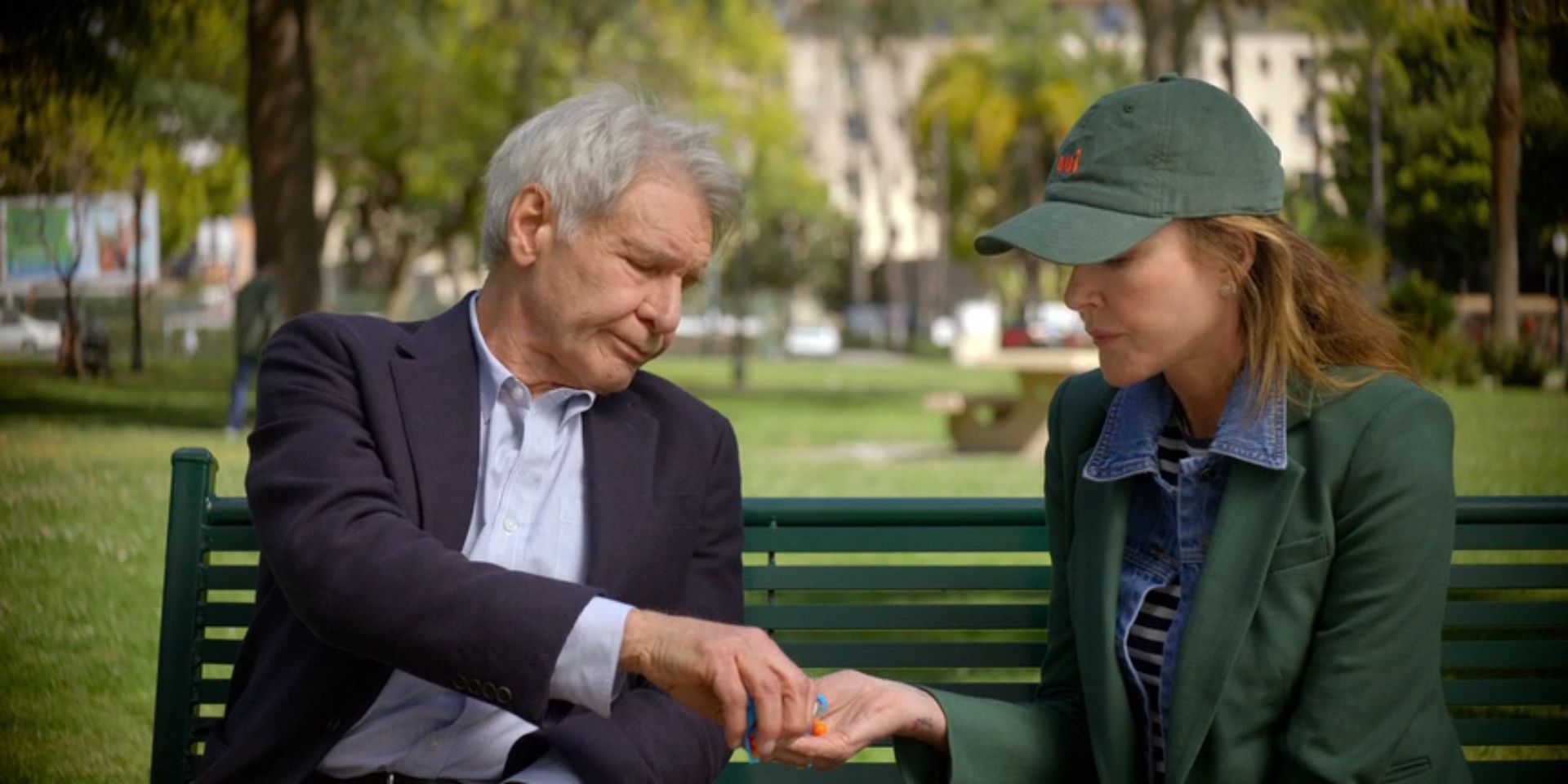 Paul, played by Harrison Ford, gives Liz, played by Christa Miller, some Skittles in 'Shrinking'.