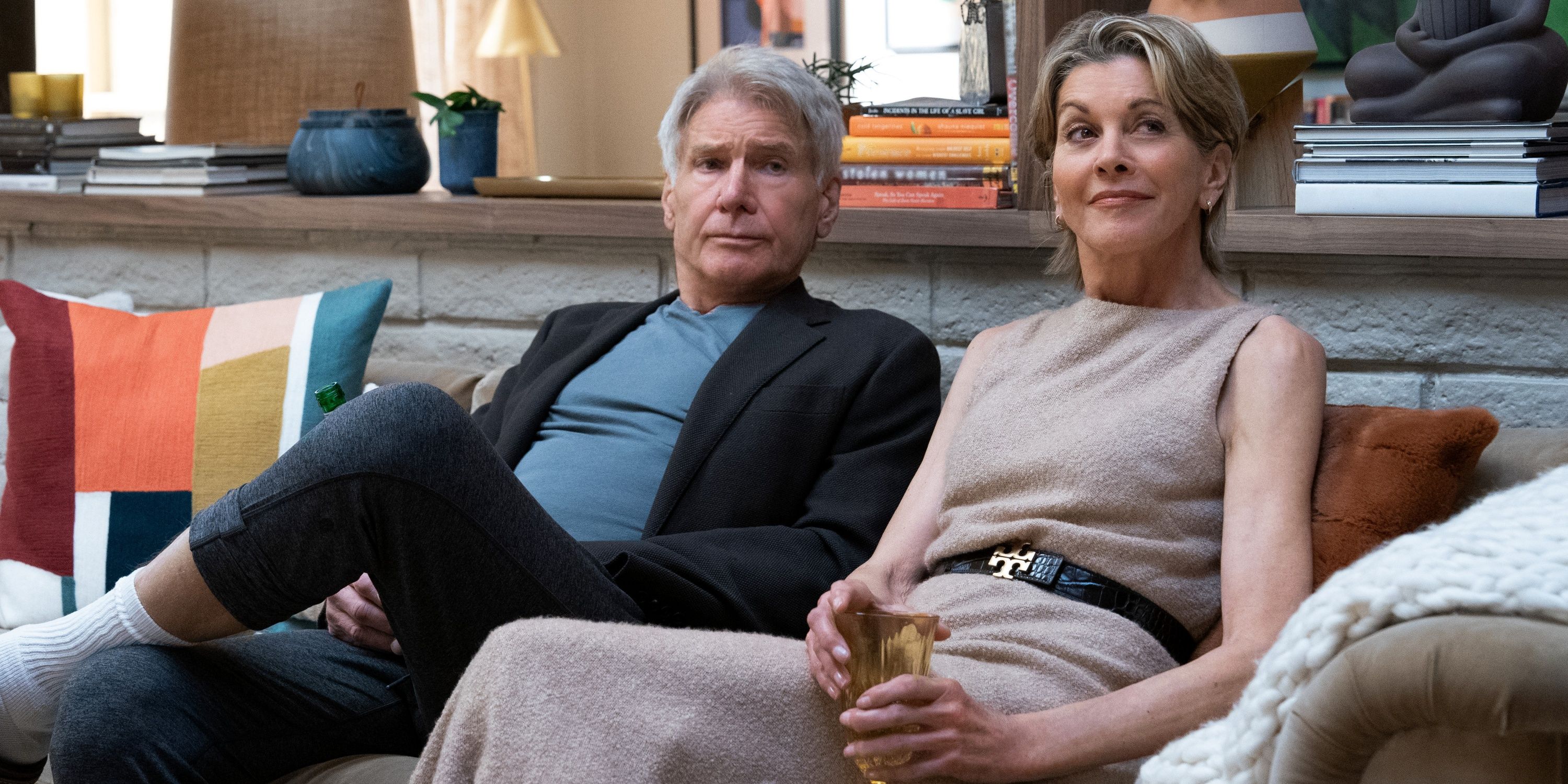 Harrison Ford as Paul sitting on the couch next to Wendie Malick on Thanksgiving in Season 2 of Shrinking