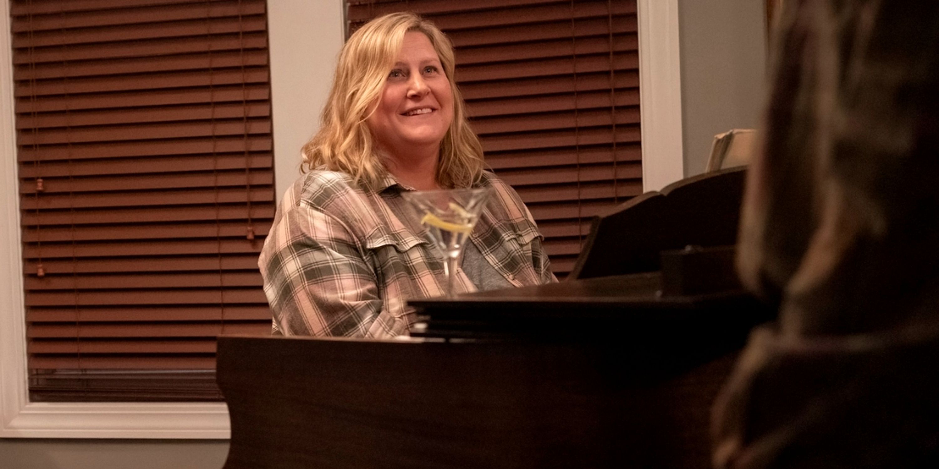 Bridget Everett as Sam sitting and playing the piano in Season 3 of Somebody Somewhere