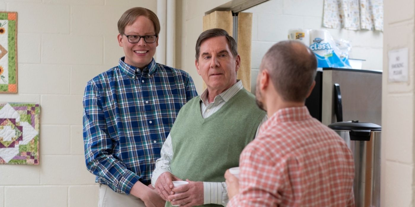 Jeff Hiller as Joel standing with Tim Bagley as Brad talking to a friend in Season 3 of Somebody Somewhere