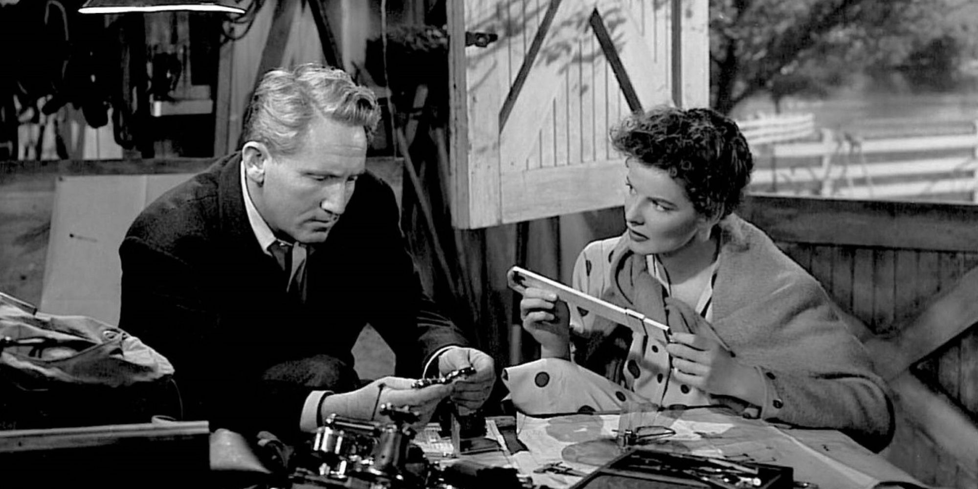 Spencer Tracy sitting next to Katharine Hepburn who is looking at him in Without Love (1945)