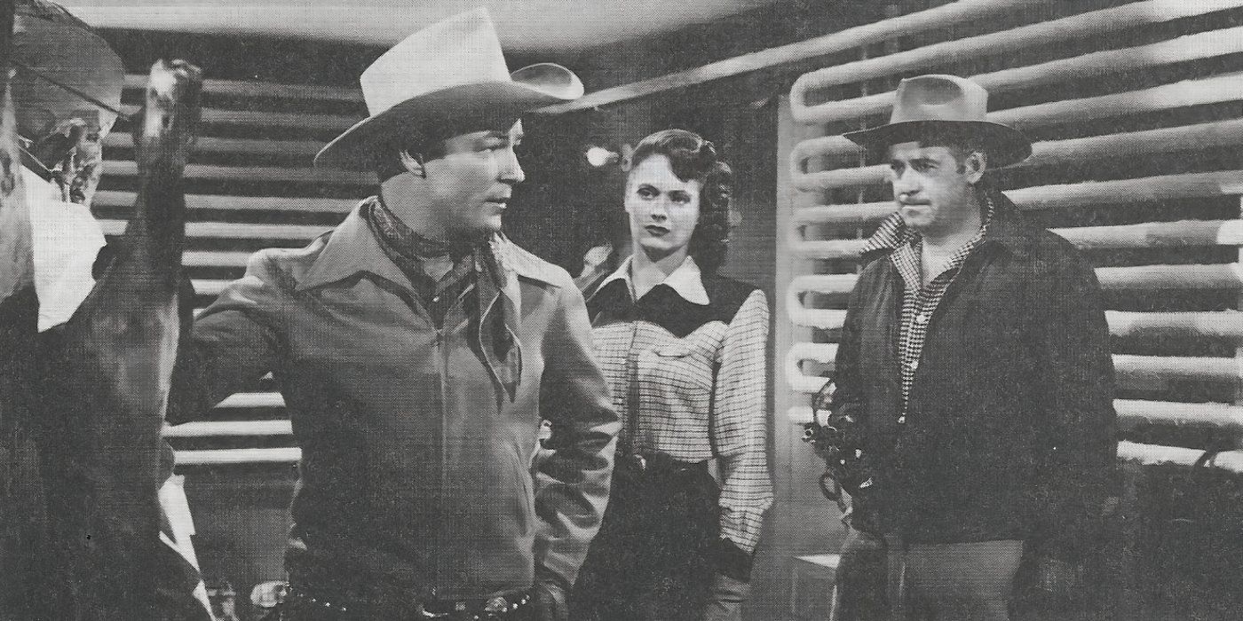 Roy Rogers and two costars talk inside a building in Springtime in the Sierras (1947).