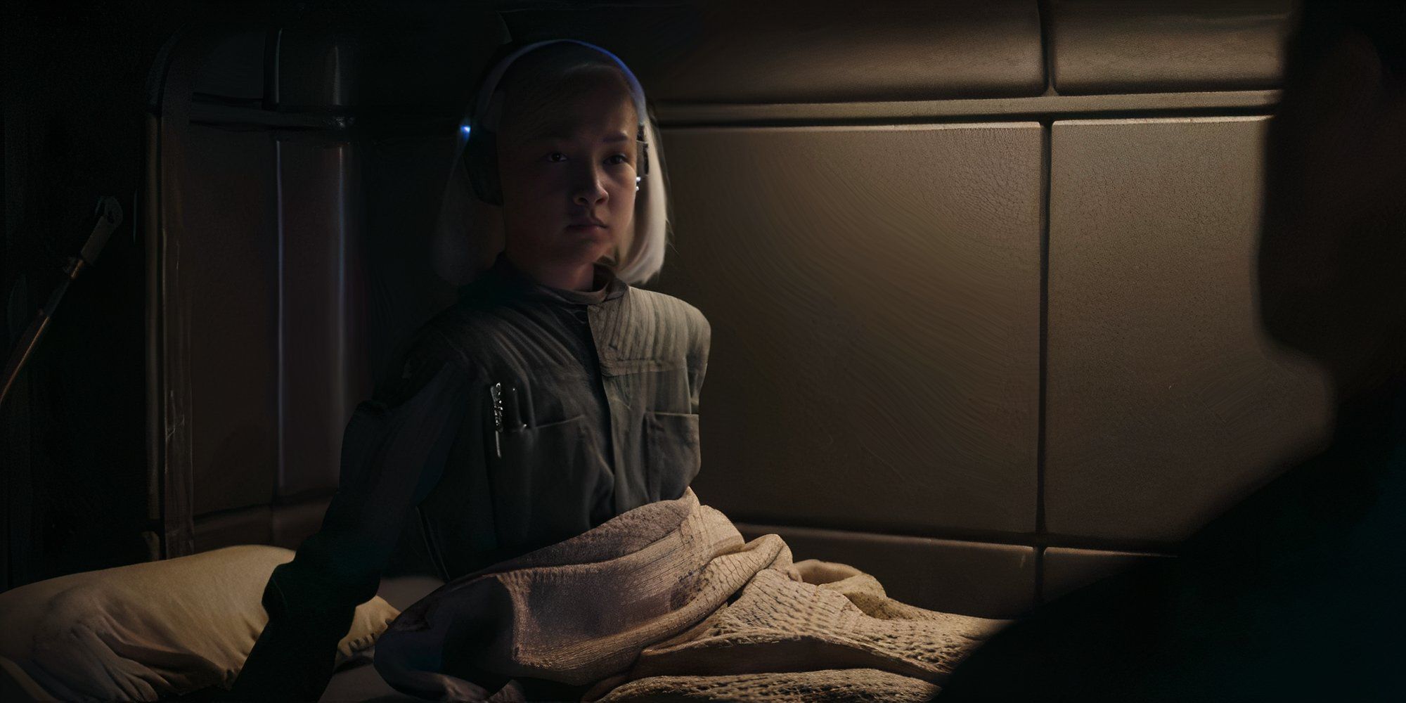 KB (Kyriana Kratter) sits up in a bed in?Star Wars: Skeleton Crew