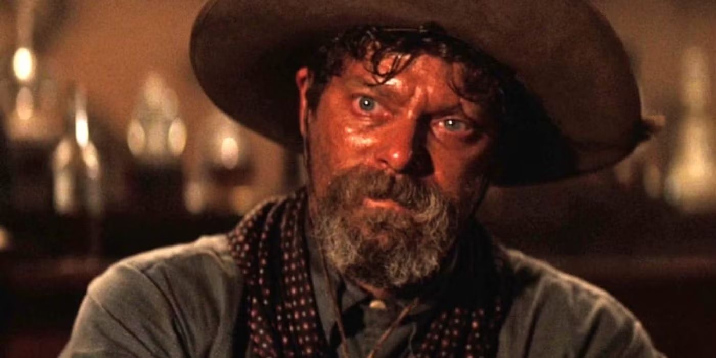 Stephen Lang as Ike Clanton wears a cowboy hat and sits in a saloon in Tombstone.